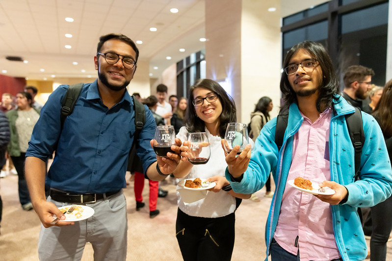 Photo of three grad students at a wine tasting